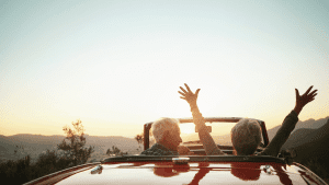 A senior couple enjoying the sunset on an afternoon drive